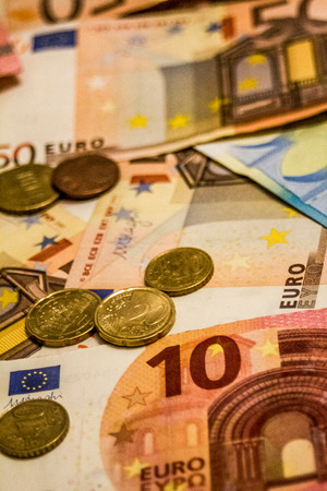 A composition of euro banknotes and coins providing great options to be used for illustrating subjects as business, banking, media, presentations etc., as well as for money related blogs or article featuresの写真素材