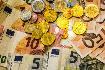 A composition of euro banknotes and coins providing great options to be used for illustrating subjects as business, banking, media, presentations etc., as well as for money related blogs or article featuresの写真素材