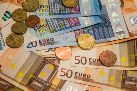 A composition of euro banknotes and coins providing great options to be used for illustrating subjects as business, banking, media, presentations etc., as well as for money related blogs or article featuresの写真素材