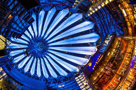 Berlin, Germany, May 13th 2016: People having a walk under the changing colours of the Sony Center...