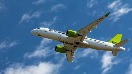 Berlin, Germany, 07.07.2018: Air Baltic Bombardier C5300 aircraft flying in the sky, Tegel Airport