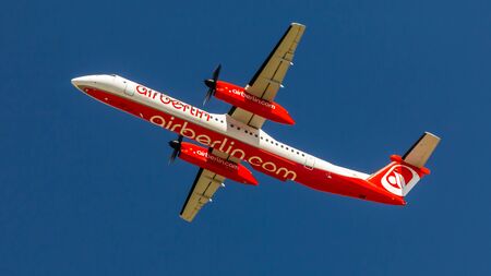 Berlin, Germany, 07.07.2018: Air Berlin Bombardier Q400 aircraft flying in the sky, Tegel Airport