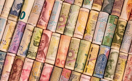 Different colourful banknotes from various countries on rolls to be used for illustrating subjects...