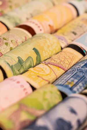 Different colourful banknotes from various countries on rolls to be used for illustrating subjects as business, banking, media, etc.の写真素材