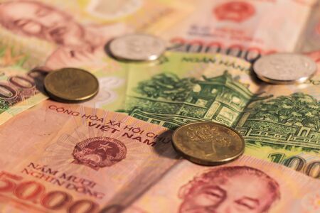 A composition of Vietnamese dong VND banknotes and coins providing great options to be used for illustrating subjects as business, banking, media, presentations etc.の写真素材