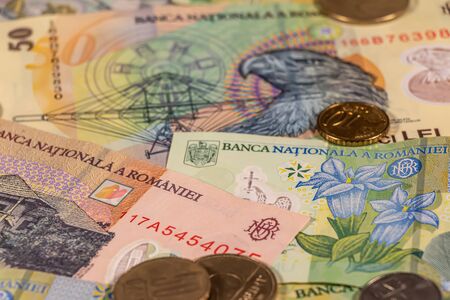 A composition of Romanian leu banknotes and coins providing great options to be used for illustrating subjects as business, banking, media, presentations etc.の写真素材