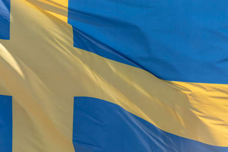 Part of Swedish national flag waving, close-up. Kingdom of Sweden, SE
