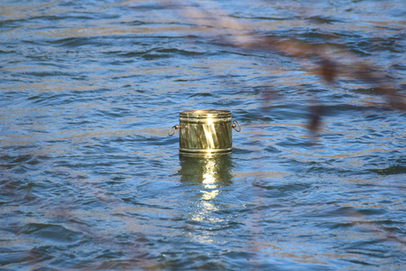 tin container in waterの写真素材