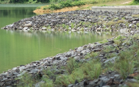 Stone bank of the river in reservoirの写真素材