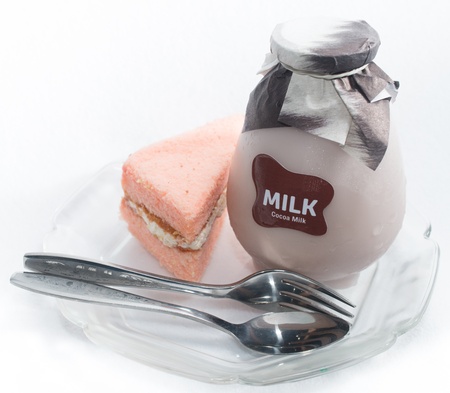 The chiffon cakes with a bottle of milk on the plateの写真素材