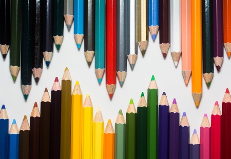 close up of color pencils with different color over white background
