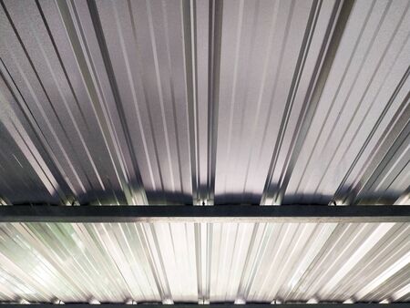 Looking up under metal sheets roofの写真素材