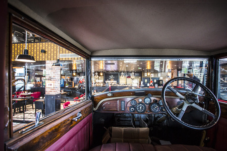The vue of a well lit, picturesque and colourful dining area from inside a decorative vintage carのeditorial素材