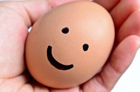 Smiling egg on handの写真素材