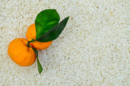 Two small oranges on the rice background