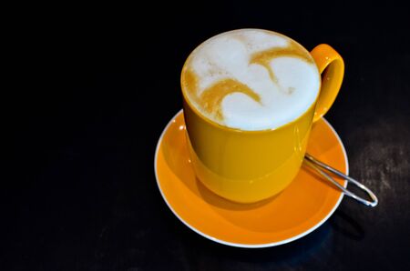 Coffee in yellow cupの写真素材