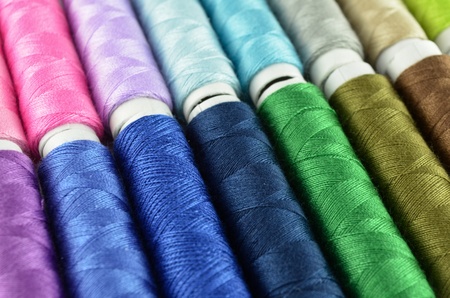 Sewing threads multicolored background closeup