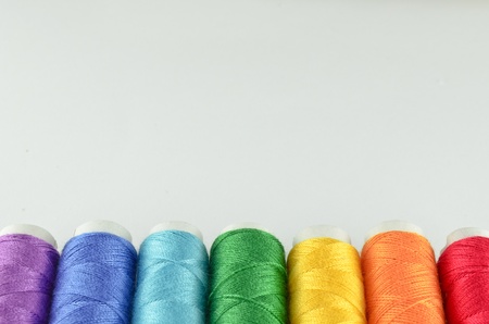 Multi-colored rainbow threads for sewingの写真素材