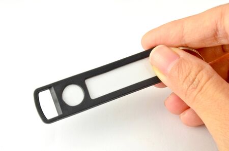 Hand holding black key chain with space for text