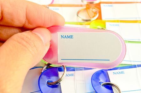 Hand holding key chain with space for textの写真素材
