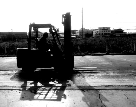 Detail worker on forklift wait for lift out cargo on struck by black and white photographyの写真素材