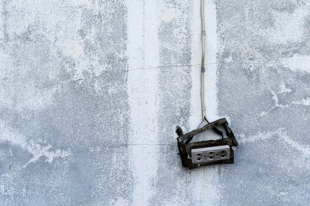 Detail old broken electric socket on dirty cement wall for backgroundの写真素材