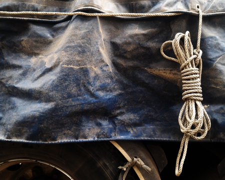 old rope loop and dirty old canvas covered truck on truck for transportation backgroundの写真素材