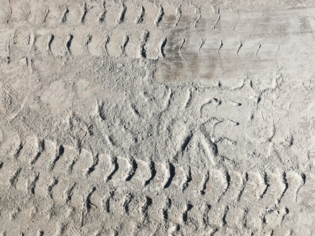 wheel track and cement powder on cement floorの写真素材