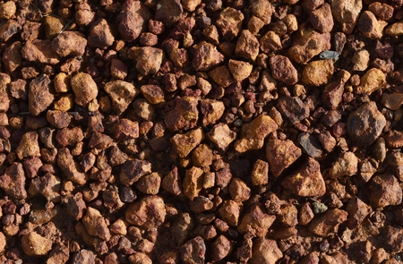 little brown stone on dry ground for brown backgroundの写真素材