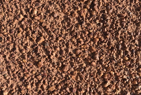 little brown stone on dry ground for brown backgroundの写真素材