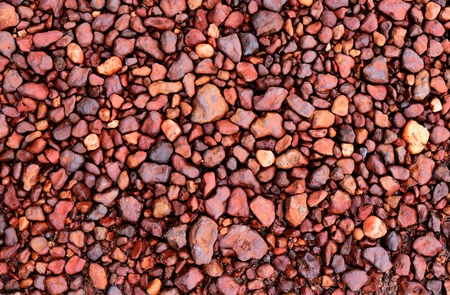 little red stone on dry ground for backgroundの写真素材
