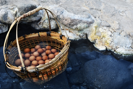 many egg in bamboo basket in hot water in hot springs at Chae Son National Park in Lampang Province, Thailandの写真素材