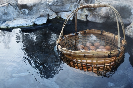 many egg in bamboo basket in hot water in hot springs at Chae Son National Park in Lampang Province, Thailandの写真素材