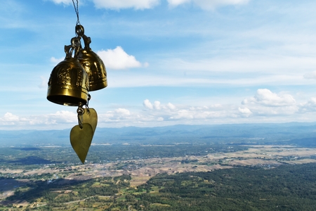 two golden bell in front of mountain and blue skyの写真素材