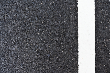 dirty white line on surface of old asphalt in countrysideの写真素材