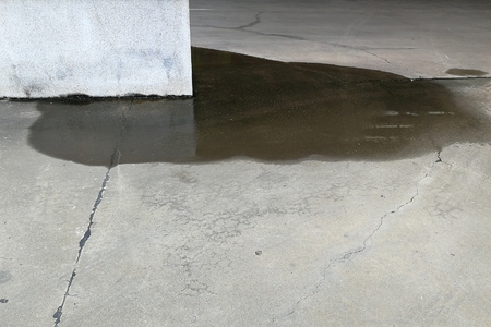 water on ground beside big poleの写真素材