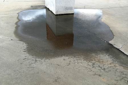 water on ground beside big poleの写真素材