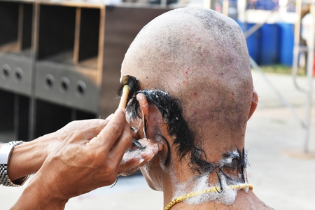 shave head by razor for ordinate monk in buddhismの写真素材