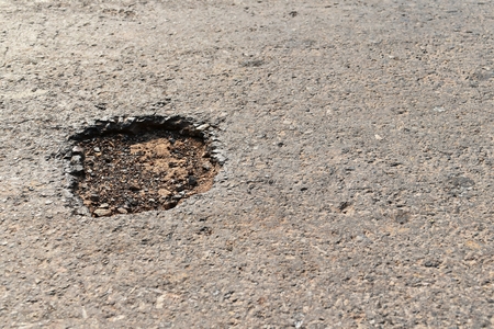 hole on asphalt road in countrysideの写真素材