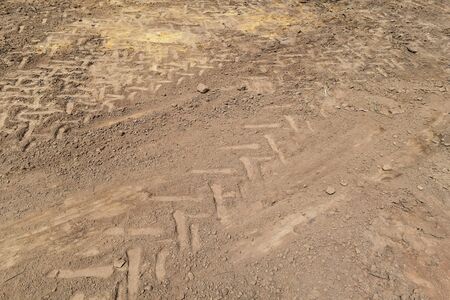 lots tire track on soil for backgroundの写真素材