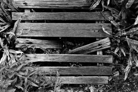 old and dirty broken wood bridge on walk way in black and white photographyの写真素材