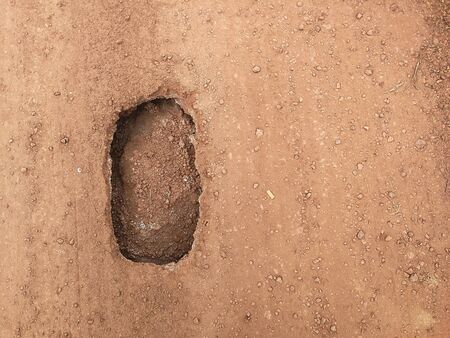 hole in dusty soil road in countrysideの写真素材