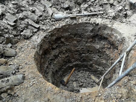 deep and big hole and old stair dig by hand of workerの写真素材