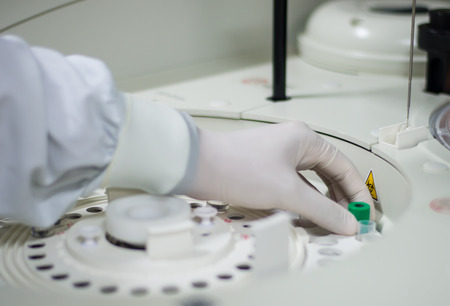 technicians operating machine in laboratory.の写真素材