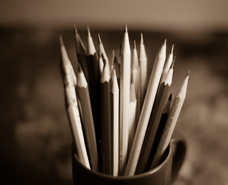 Stack of pencils in a glass on wooden background,tone sepiaの写真素材