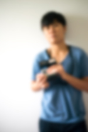 Blurred photographer in hipster style.with retro photo cameraの写真素材