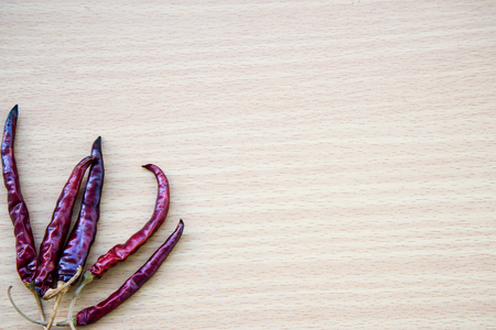 Chili peppers on wooden plankの写真素材