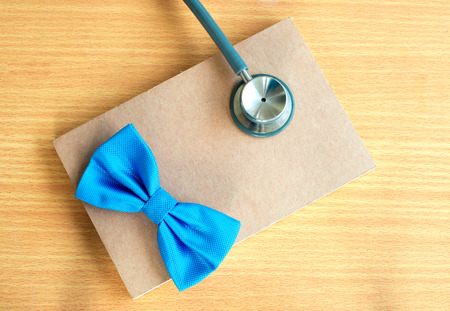 Blue bow with stetoscope  close up on notebook.