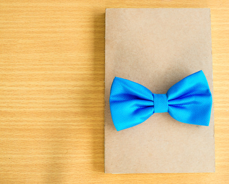 Blue bow close up on notebook.の写真素材