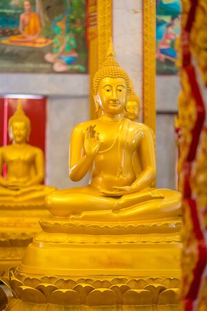 golden seated buddhas in a Buddhist temple in Thailand.の写真素材